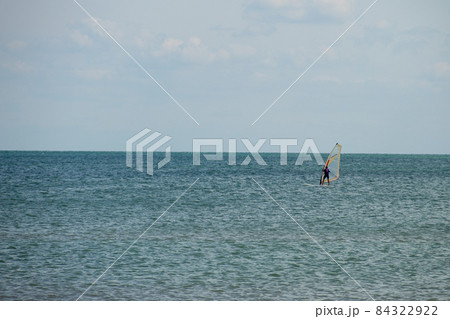 Windsurfing. Surfer exercising in calm sea or ocean. 84322922