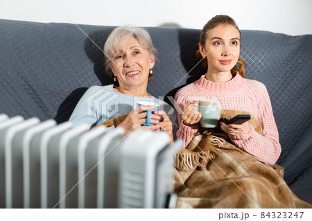 Grandmother and granddaughter watching TV 84323247