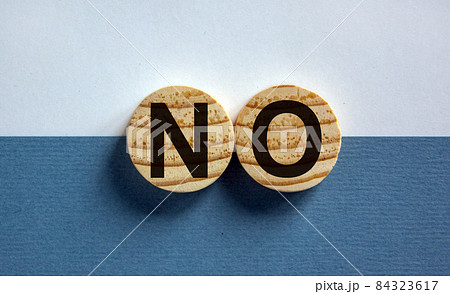 Wood circles with word 'no' on paper white and blue background, copy space. Business concept. Wood circles with word 'no' on paper white and blue background, copy space. Business concept. 84323617