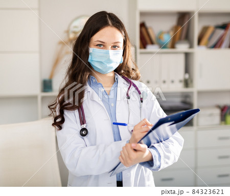 Woman doctor wear white medical uniform and stethoscope in mask Woman doctor wear white medical uniform and stethoscope in mask 84323621