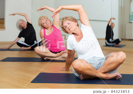 Group of mature women exercising in lotus pose 84323853