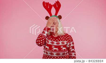 Upset senior Christmas old woman making face palm gesture, feeling bored, disappointed, bad result Upset senior Christmas old woman making face palm gesture, feeling bored, disappointed, bad result 84326934