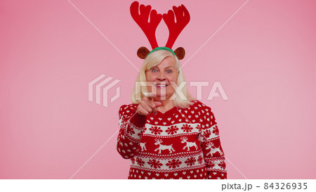 Senior Christmas grandmother woman smiling excitedly pointing to camera beauty choosing lucky winner 84326935