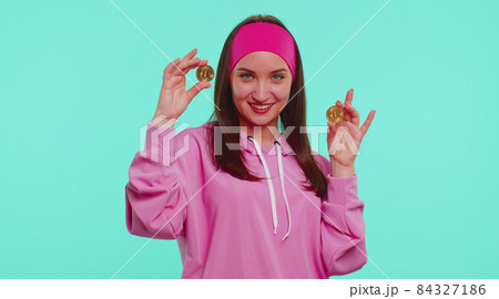 Teenager girl showing golden bitcoins, career, cryptocurrency investment, mining, future technology Teenager girl showing golden bitcoins, career, cryptocurrency investment, mining, future technology 84327186