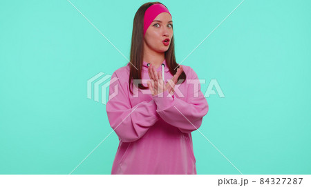 Confused teenager girl pointing fingers himself ask say who why me no thanks i do not need it 84327287