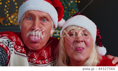 Mature family taking selfie on mobile phone, communicating video call online celebrating Christmas 84327560