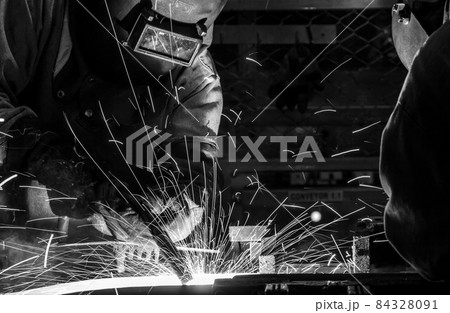 worker with protective mask welding metal 84328091