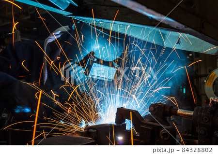 worker with protective mask welding metal 84328802