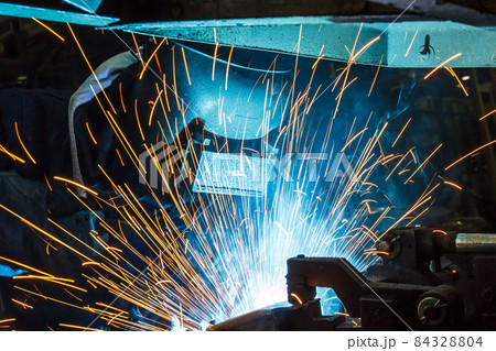 worker with protective mask welding metal 84328804