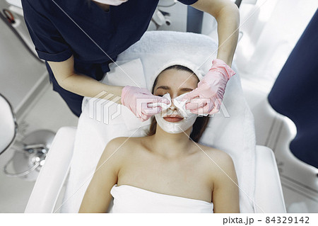 Woman in cosmetology studio on a procedures 84329142