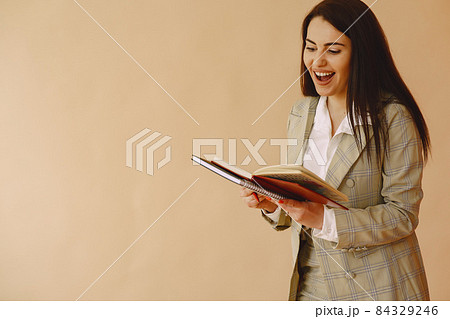 Woman standing on a brown background 84329246