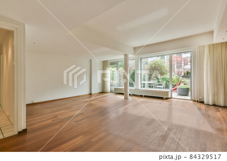Huge room with wooden floor and columns Huge room with wooden floor and columns 84329517