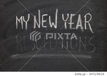 forgetting new year resolutions - concept on blackboard 84329626