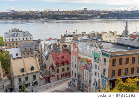 Quebec, Canada - October 20 2021 : Fresco Wall Art in the Quebec City Old Town in autumn sunny day. Mural of Quebecers. 84331392