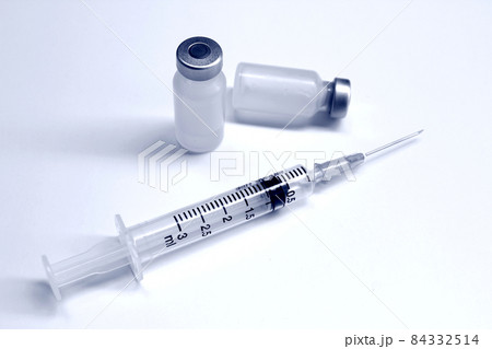 Vial of drugs or vaccine and 3 ml plastic syringe with needle isolated on the white background, blue tone color 84332514
