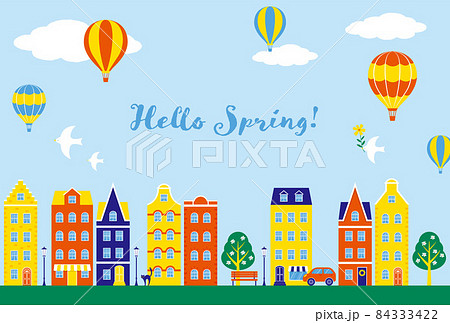 空に浮かぶ気球とカラフルな家や店が立ち並ぶ街のイラストの背景素材のイラスト素材