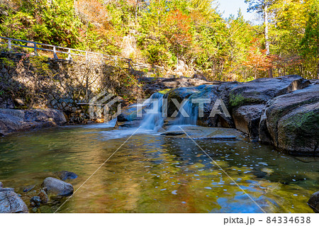 長野県上松町　紅葉に包まれた赤沢自然休養林内の渓流とオープントロッコ列車の橋 84334638