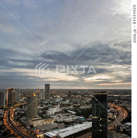 Gorgeous panorama scenic of the sunrise or sunset with cloud on the orange and blue sky over large metropolitan city in Bangkok. 84334920