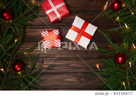 gift boxes and fir branches on a wooden background. 84336677