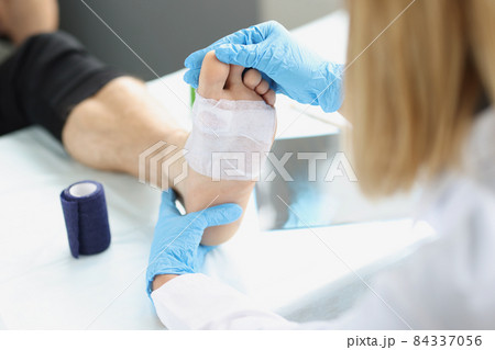 Dermatologist traumatologist conducts medical examination of patient mortar 84337056