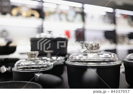 Set of pots and pans with lids in kitchen 84337057