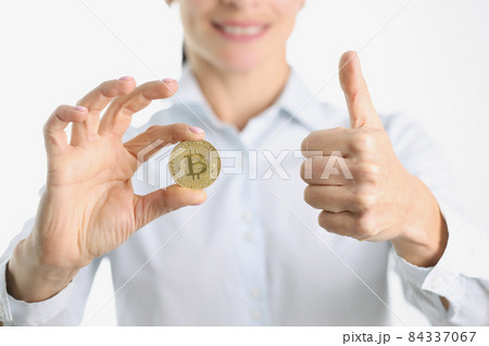 Gold bitcoin and thumbs up in female hand 84337067