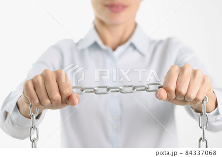 Businessman firmly holds chrome chain in hands 84337068