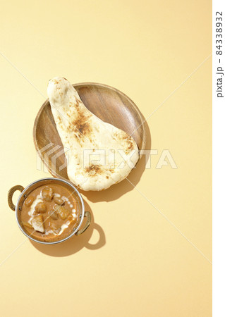 鶏肉や落花生など沢山の具材が入っているマッサマンカレーとナンを俯瞰で撮影 84338932