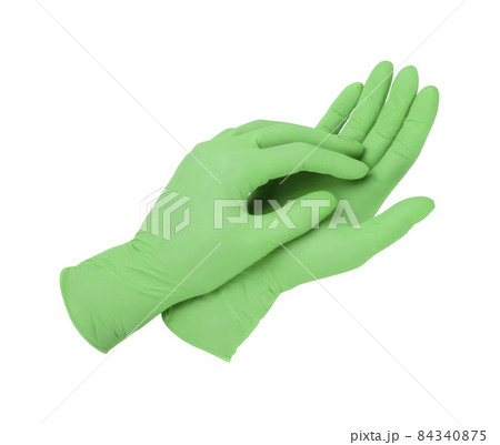 Medical gloves. Two green surgical gloves isolated on white background with hands. Rubber glove manufacturing, human hand is wearing a latex glove. Doctor or nurse putting on protective gloves. 84340875