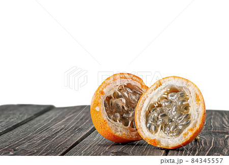 Two halves of tamarillo on wooden table Two halves of tamarillo on wooden table 84345557