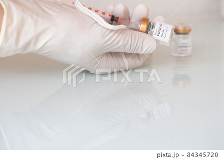 Medical assistant is about to administrate vaccine. 84345720