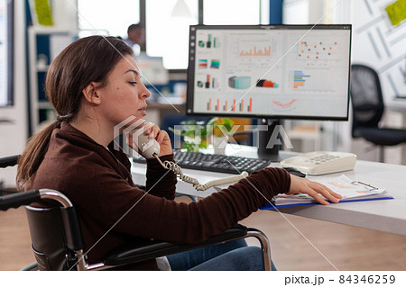 Disabled businesswoman in wheelchair discussing marketing strategy Disabled businesswoman in wheelchair discussing marketing strategy 84346259