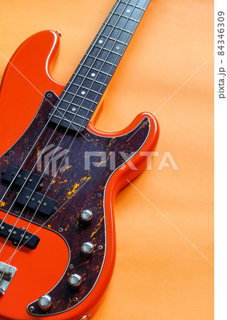 orange electric bass guitar on orange background orange electric bass guitar on orange background 84346309