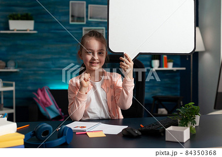 Portrait of smiling little child holding white banner looking into camera 84350368