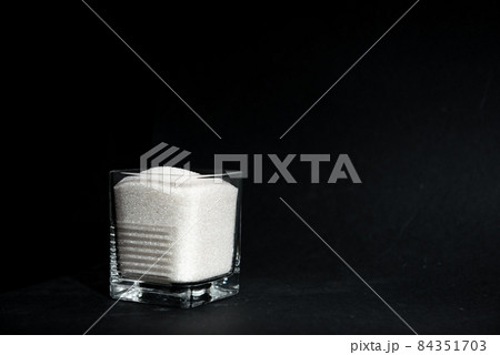 sugar in a transparent glass with copy space 84351703