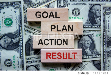 Wooden blocks form the words 'goal, plan, action, result' on beautiful background from dollar bills. Business concept. Copy space. Wooden blocks form the words 'goal, plan, action, result' on beautiful background from dollar bills. Business concept. Copy space. 84352563