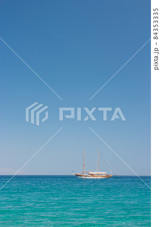 Beautiful sailboat sailing on sea against clear blue sky. White yacht in sea. Beautiful sailboat sailing on sea against clear blue sky. White yacht in sea. 84353335