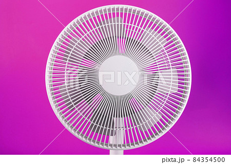 White modern electric fan for cooling the room on a pink background. 84354500