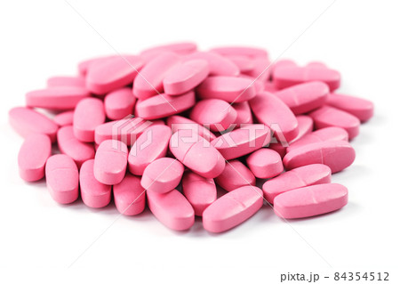 Pink vitamin pills for women on a white background. 84354512