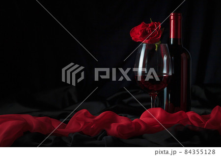 Bottle and glass of red wine with red rose. Bottle and glass of red wine with red rose. 84355128