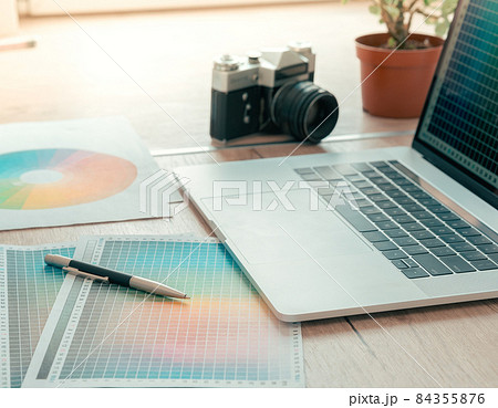 close up. laptop, camera and color palette on the table of designer . 84355876