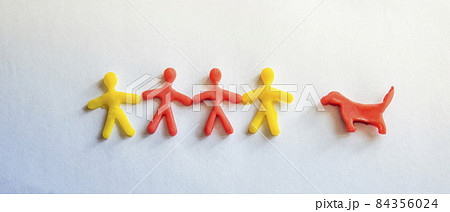 silhouettes of people and a dog made of dough on a light background silhouettes of people and a dog made of dough on a light background 84356024