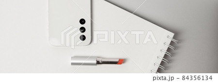 Minimalist and clean Female workspace with laptop, smart phone , notebook, and red lipstick 84356134