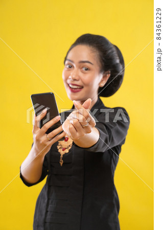 woman wearing traditional Javanese clothes with hand gestures symbol of love woman wearing traditional Javanese clothes with hand gestures symbol of love 84361229