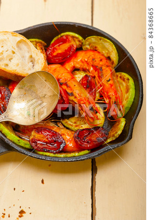 roasted shrimps with zucchini and tomatoes 84368665