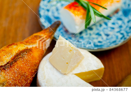 French cheese and fresh  baguette on a wood cutter 84368677