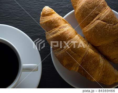 Cup of coffe and croissants 84369466