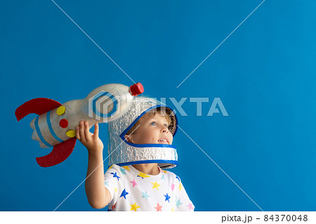 Happy child playing toy rocket 84370048