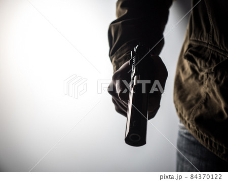 Man holding a gun Man holding a gun 84370122