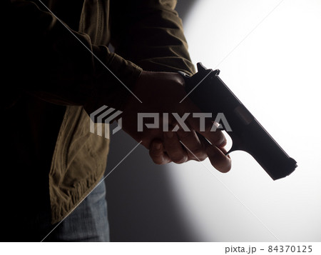 Man holding a gun Man holding a gun 84370125